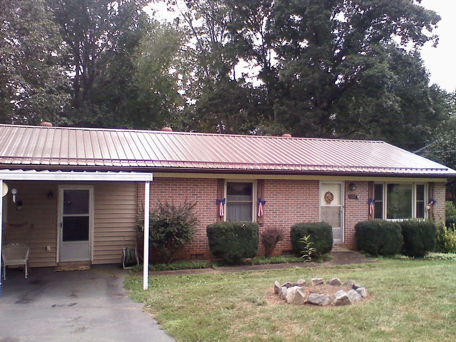 Bronze metal roof and carport on a brick ranch home — Roof Repair work by our crew in Palenville